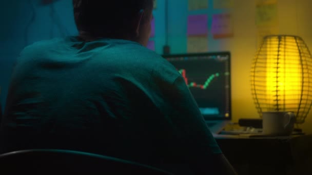 Europejczyk Crypto Handlowiec Siedzi Laptopem Ciemnym Pokoju Neonowym Światłem Patrzy — Wideo stockowe