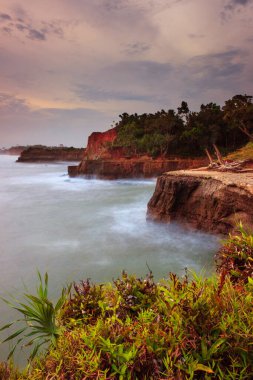 picture of cliffs with blue breathing water and coral abrasion beach in Indonesia, Bengkulu view from the top view from the top of the mountain. Travel paradise destination for summer adventure