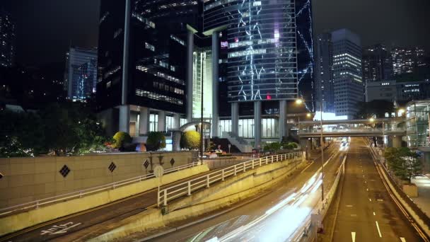 Tráfego noturno perto dos arranha-céus da cidade de Hong Kong — Vídeo de Stock