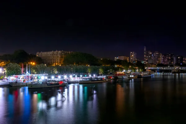 フランスだ パリの夏の夜 セーヌ川堤防には遊覧船が係留されています 多色のライトがたくさんある — ストック写真