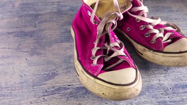 Dirty Pair Sneakers Poorly Painted Concrete Floor Shoelaces Falling Slow — Stock Video