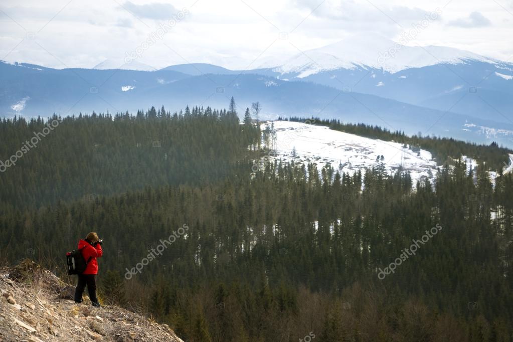 Photographer with mountains  and sky background