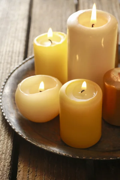 Golden candles on wooden table — Stock Photo, Image