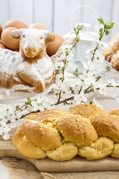 Loaf of sweet bread and cherry blossom twig — Stock Photo, Image
