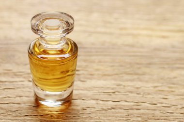 Ahşap zemin üzerine altın esans ile şişe