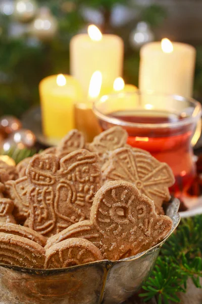 Ciotola di biscotti speculaas, candele dorate sullo sfondo . — Foto Stock
