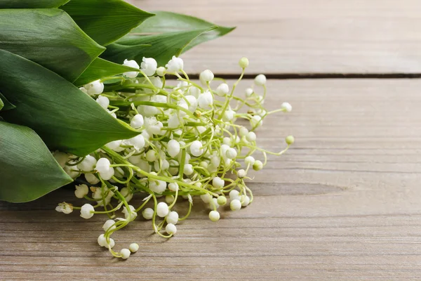 Lily of the valley flowers on wooden background. — Stock Photo, Image