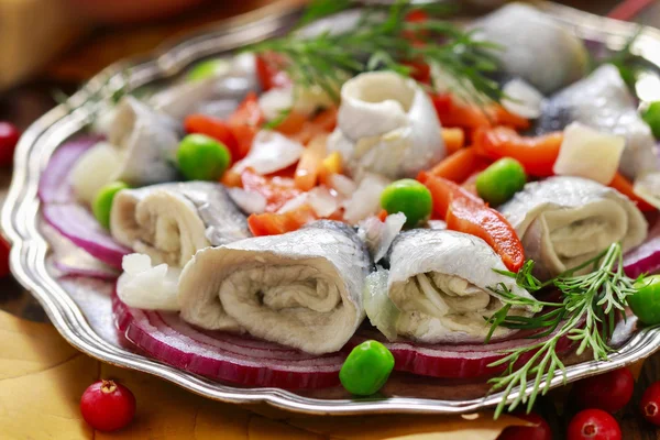 Pickled herring rolls with vegetables — Stock Photo, Image