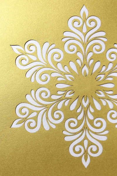 White snowflake shape on golden background — Stock Photo, Image