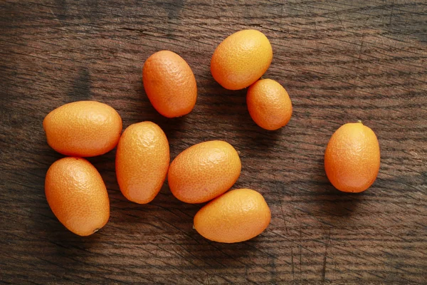 Ripe kumquats on wooden background — Stock Photo, Image