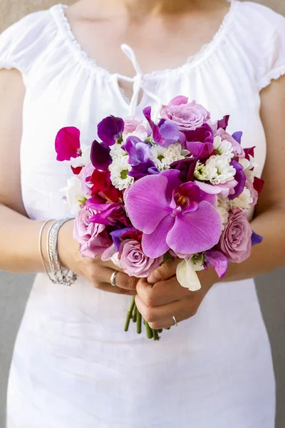 Bride holding bouquet with purple orchids, roses and freesias — Stock Photo, Image