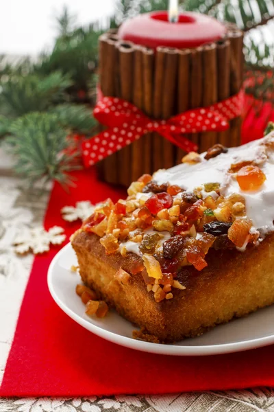 Fruitcake with dried fruits and nuts in christmas setting — Stock Photo, Image