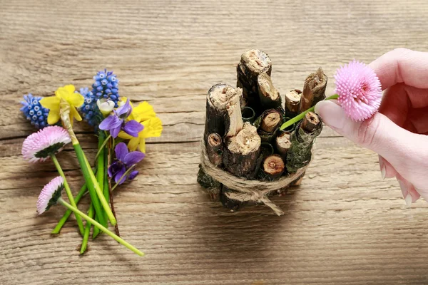 Florist at work: woman making spring table decoration with stick — Stock Photo, Image