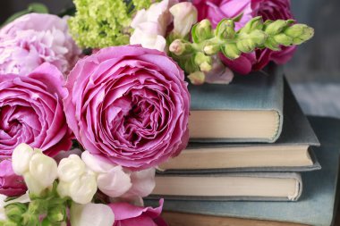 Old books and bouquet of flowers clipart