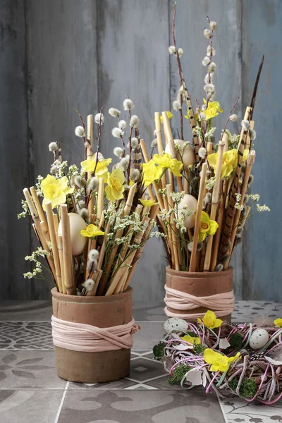 Floral arrangement with yellow daffodils and bamboo sticks. — Stock Photo, Image