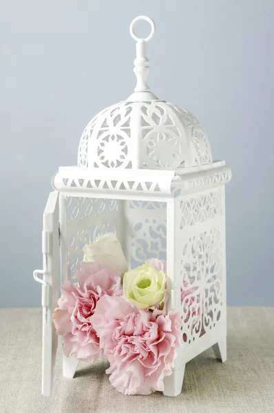 Vintage iron lantern with flowers inside — Stock Photo, Image