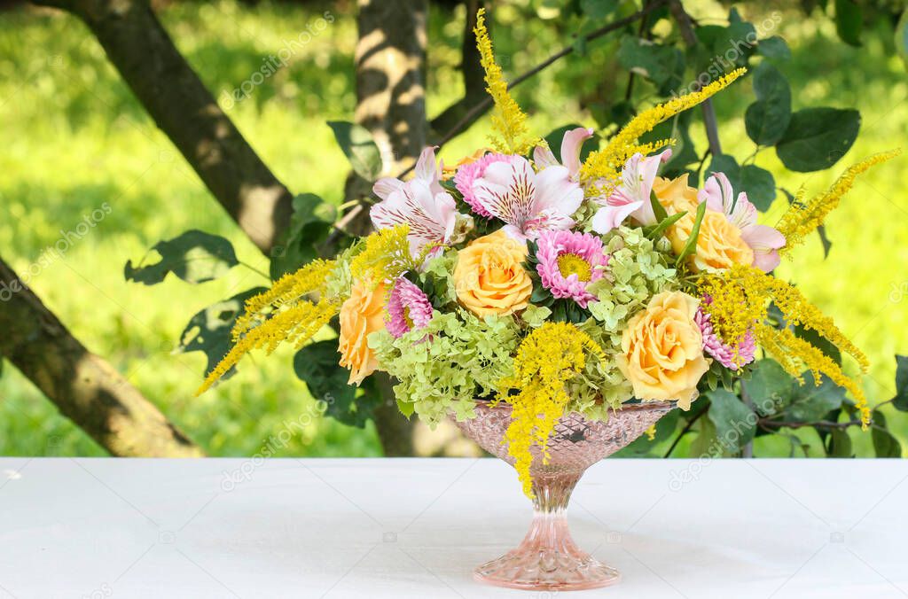 Floral arrangement with roses, alstroemeria and solidago flowers inside a vintage bird cage. Step by step, tutorial