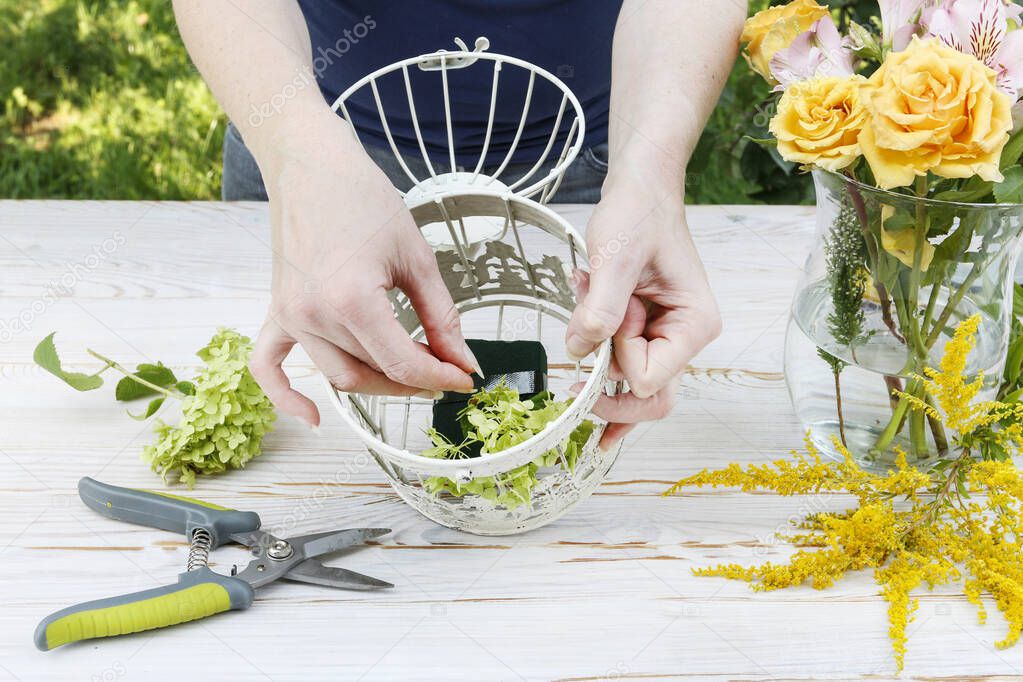 Florist at work: How to make modern table's centerpiece for summer wedding. A lot of greenery being composed into stunning arrangement. Step by step, tutorial.