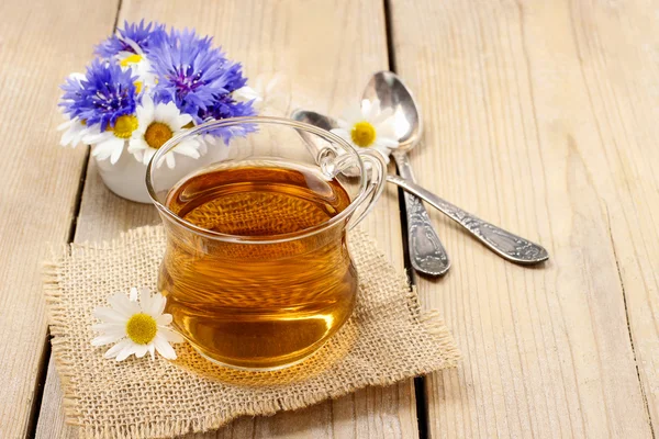 Chamomile tea on wooden table — Stock Photo, Image