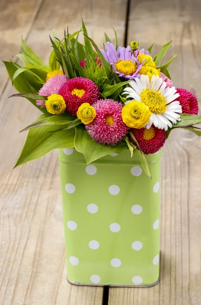 Bouquet of colorful wild flowers in green dotted can — Stock Photo, Image