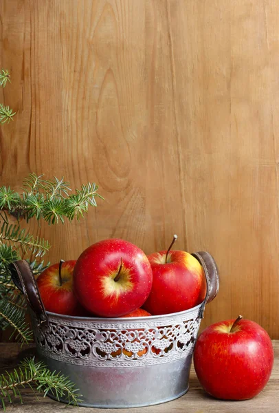 Silver bucket of red apples on wooden table. — Stock Photo, Image