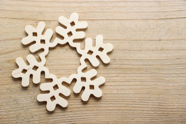 Snowflake made of wood on wooden background — Stock Photo, Image