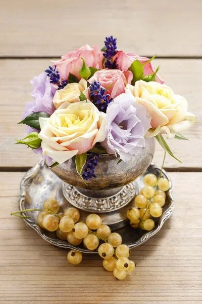 Bouquet of roses and eustomas in vintage silver vase — Stock Photo, Image