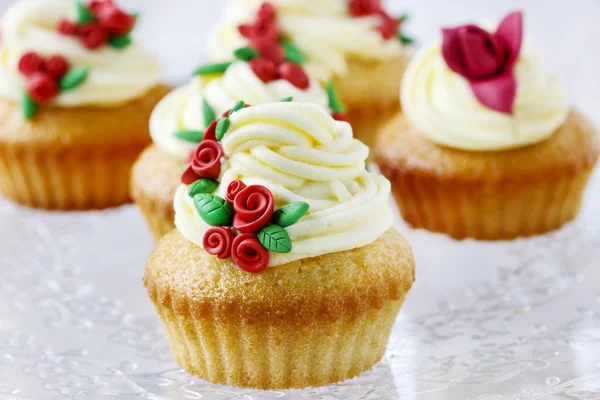 Hochzeitsempfang Cupcakes mit Zuckerwerk roten Rosen dekoriert — Stockfoto