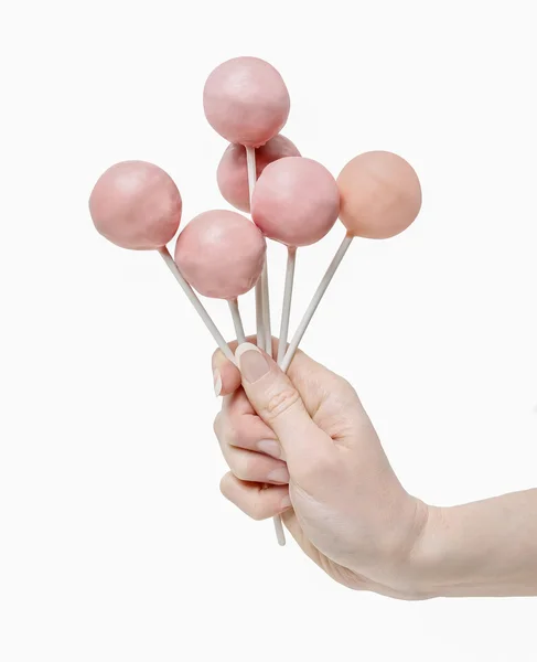 Kvinna med några rosa cake pops i hand — Stockfoto