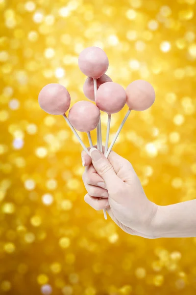 Mujer sosteniendo un poco de pastel rosa aparece en la mano —  Fotos de Stock