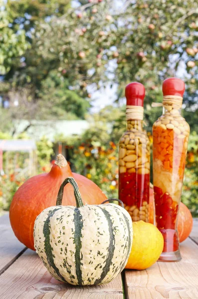 Pumpkins on wooden table in the garden — Stock Photo, Image