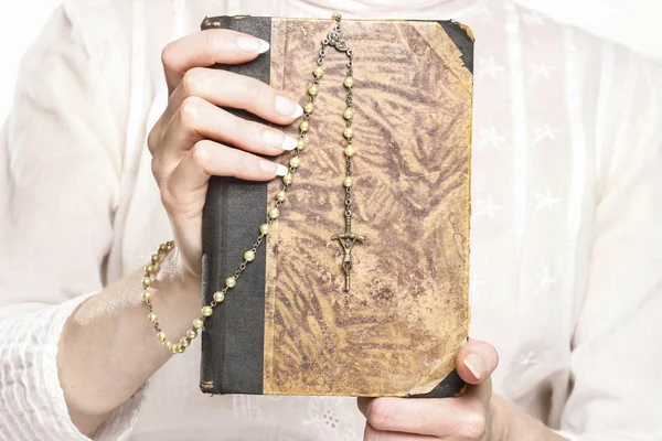 Jovem segurando uma Bíblia Sagrada e um rosário — Fotografia de Stock