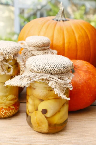 Pumpkins and colorful pickled vegetables in preserving glass — Stock Photo, Image