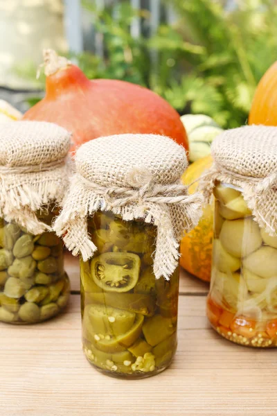 Pumpkins and colorful pickled vegetables in preserving glass — Stock Photo, Image