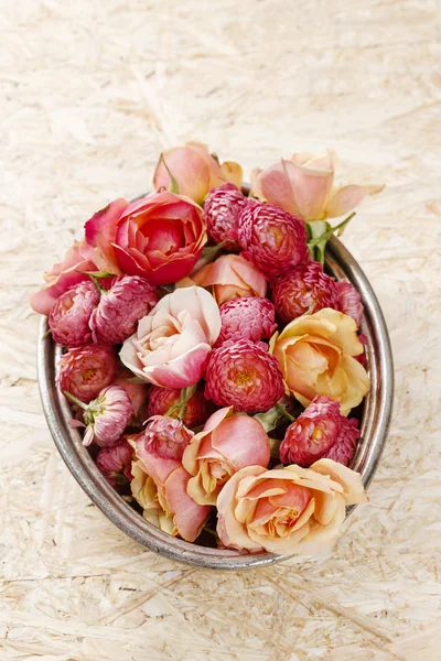 Pile of flowers in silver bowl — Stock Photo, Image