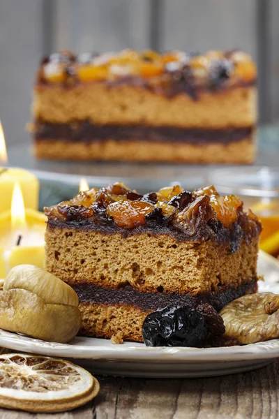 Delicious layer gingerbread cake decorated with dried fruits — Stock Photo, Image