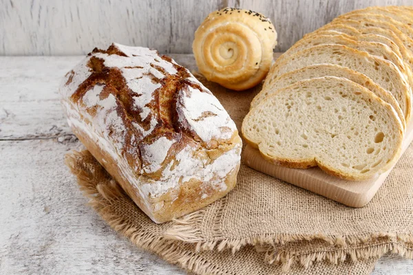 Bröd på vit trä bakgrund — Stockfoto