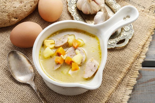 Portion of the sour rye soup made of soured rye flour and meat — Stock Photo, Image