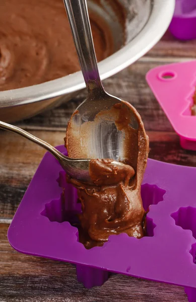 Steps of making chocolate cake: filling silicone mold with pastr — Stock Photo, Image