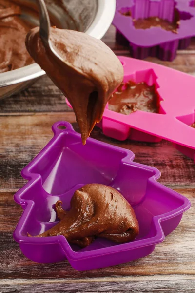Steps of making chocolate cake: filling silicone mold with pastr — Stock Photo, Image