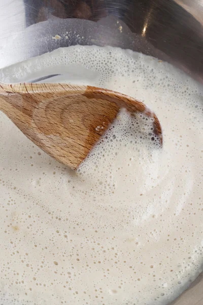 How to make yeast dough - step by step: mix dry yeast with milk — Stock Photo, Image