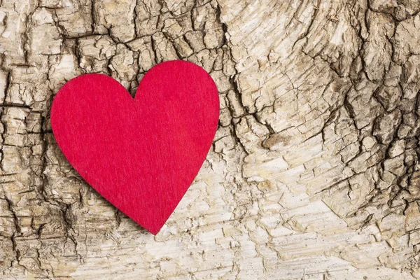 Red heart on bark background. Symbol of love — Stock Photo, Image