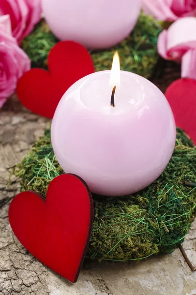 Pink candle and wooden red heart — Stock Photo, Image