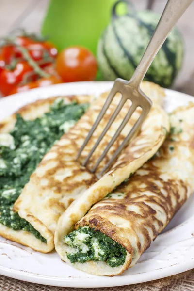 Mediterranean cuisine: crepes stuffed with cheese and spinach — Stock Photo, Image