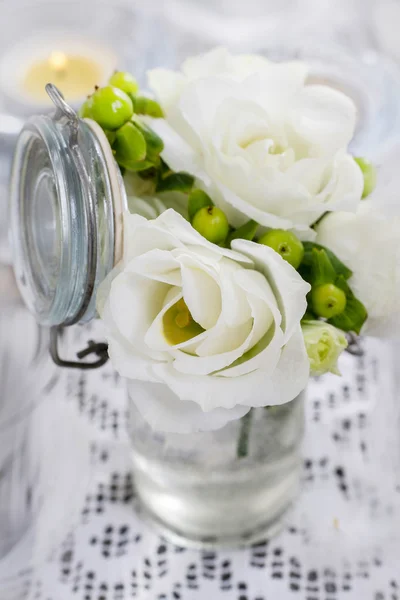 Tiny bouquet of white eustoma flowers and green hypericum plant — Stock Photo, Image