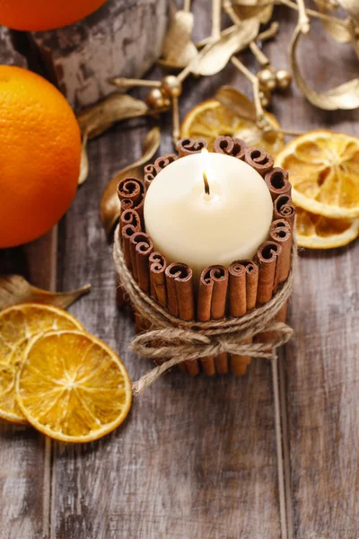 Candle decorated with cinnamon sticks — Stock Photo, Image