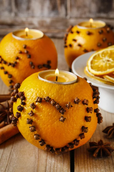 Orange pomander ball with candle decorated with cloves in heart — Stock Photo, Image
