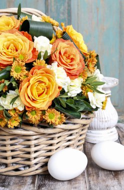 Bouquet of orange roses and ivory carnation flowers