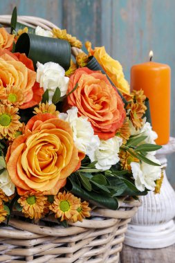 Bouquet of orange roses and ivory carnation flowers