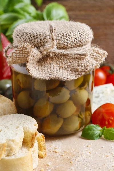 Glass jar of green olives — Stock Photo, Image